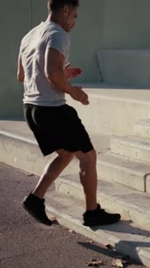 Young Adult Exercising by Running Up Stairs
