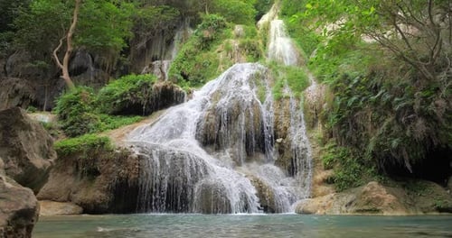 Beautiful Jungle Waterfall Cascades Down Mossy Green Cliffs