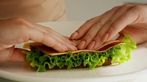 Hands Preparing an Open Faced Sandwich Close Up