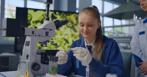 Smiling Student Girl In Educational School Laboratory Studying Chemistry Viewing Chemical Reaction