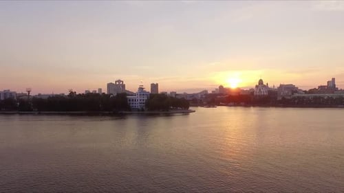 Aerial view of Sunrise in a big city on the river. 01