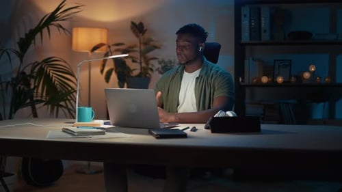 Engaged Young Man on Video Call at Desk