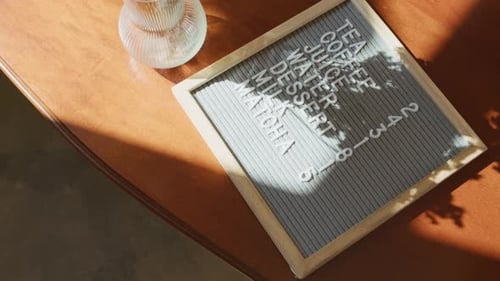 Cafe Menu Board on Table next to Vase with Everlasting Flowers