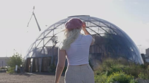 Woman Looking at Geodesic Dome on Sunny Day