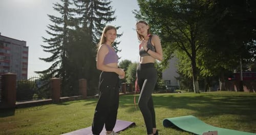 Young Sportswomen Giving High Five in Park