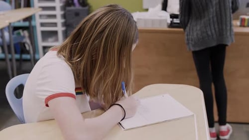 Focused Tween Studying at School Desk