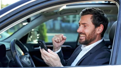 Businessman Celebrating Success In Car