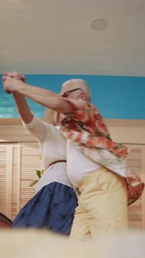 Happy Senior Couple Dancing and Embracing Indoors