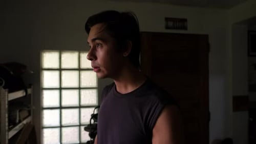 Caucasian Male Drinking Coffee by Apartment Window