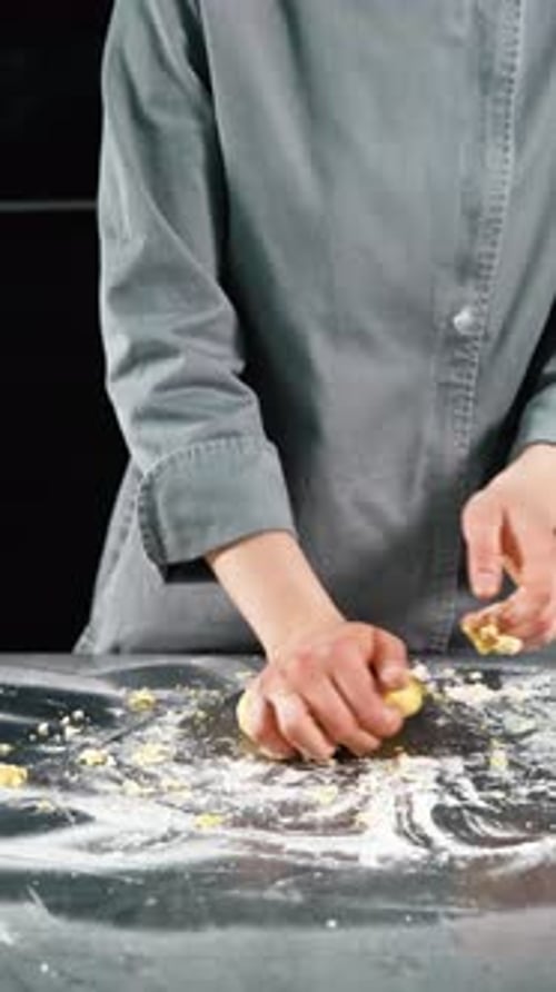 Close Up of Hands Kneading Dough on Table
