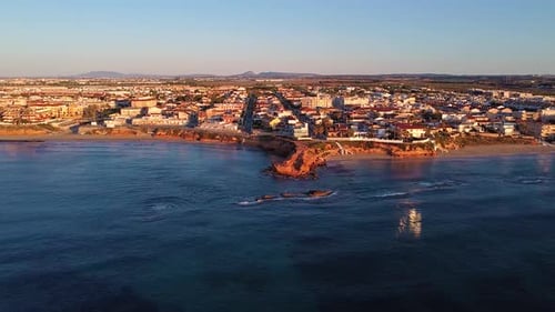 Aerial drone view of cityscape and coastline of Mil Palmeras beach and Pilar de la Horadada in Spain