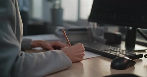 In Modern Office Close Up of Female Financial Specialist Taking Notes