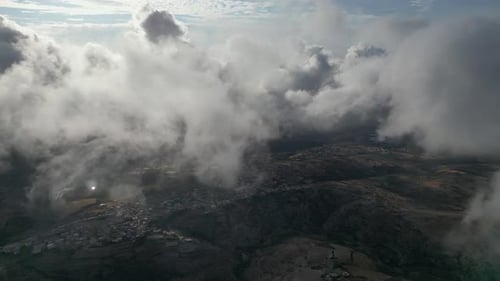 Spectacular Aerial View Between White Clouds Above Charming, Peaceful Small Towns.