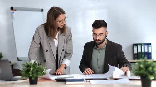 Design Team Discussing Architectural Plans in Office