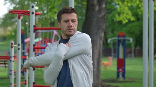 Man Stretching Before Outdoor Workout in Park Athlete Prepares for Training