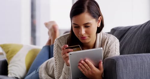 Woman Shops Online Lying on the Couch