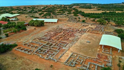 Panoramic drone shot circling the ruins of the Palace of Knossos in Crete, Greece