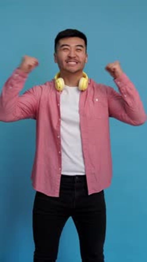 Excited Man Celebrates Against a Blue Background