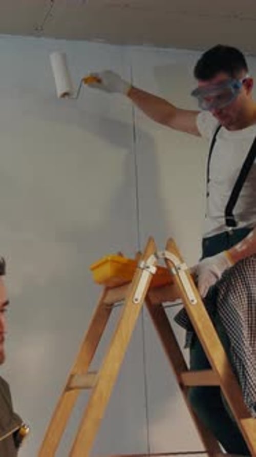 NEW YORK April 5 2017 One of the Skilled Builders Puts the Painting Trail on the Ladder Assisting to