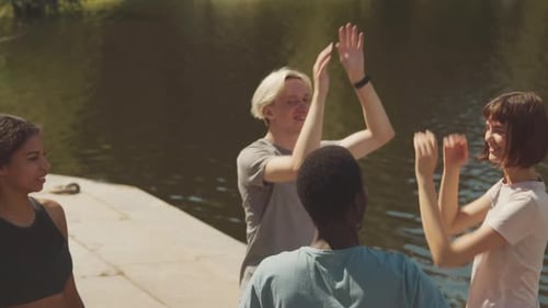 Enthusiastic Friends Give High Fives Outdoors
