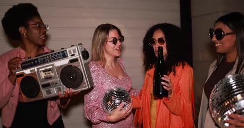Diverse Group of Young Women Celebrating with Music and Disco Balls