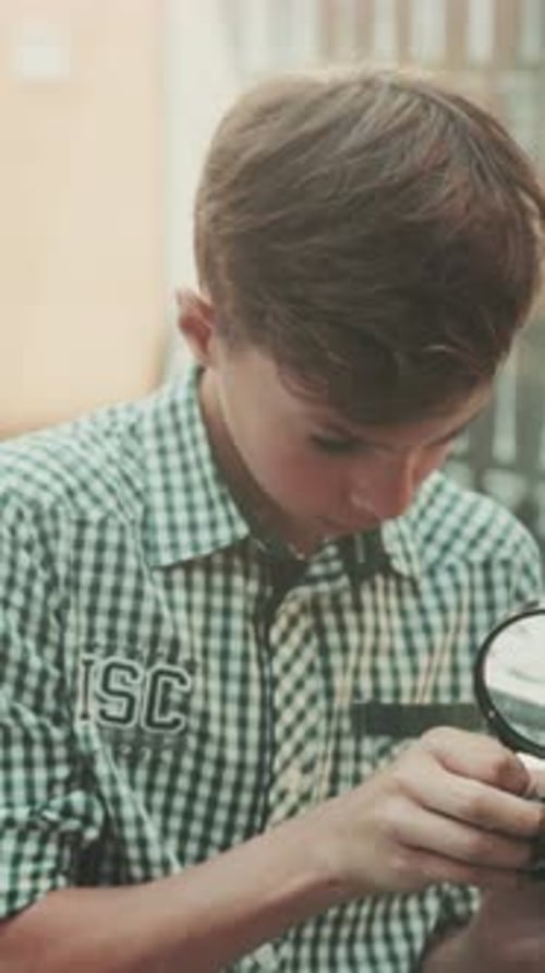 Young Inventor Examines Robot Parts Focused Adolescent Studies Intricate Metal Gears Quietly and