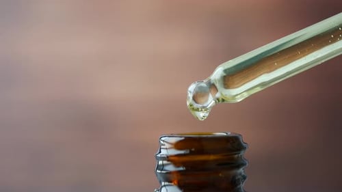 Essential Oil Dropping From a Pipette