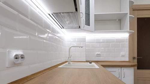 Modern Kitchen Interior with White Tile and Wood Counter