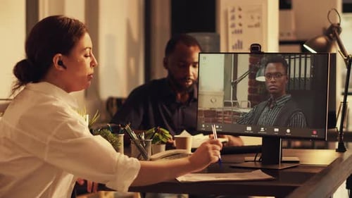 Confident Manager Attending Online Teleconference Meeting with Colleague