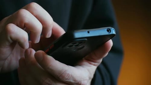 Person's Hands Using Smartphone for Scrolling and Texting