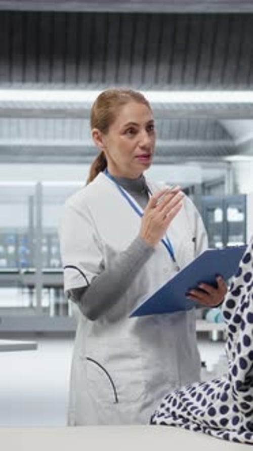 Healthcare worker talks to patient in modern hospital