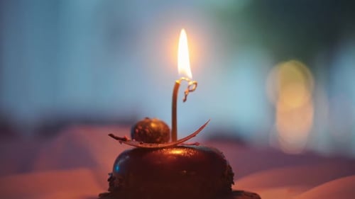 Ornate Candle Holder and Lit Candle Close Up