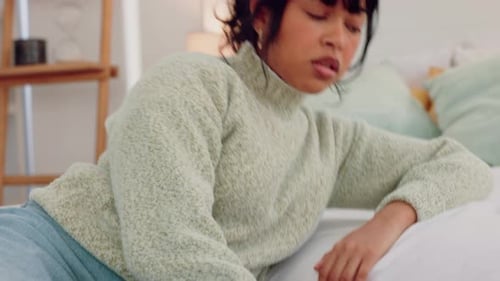 Woman Resting on Bed in Daytime