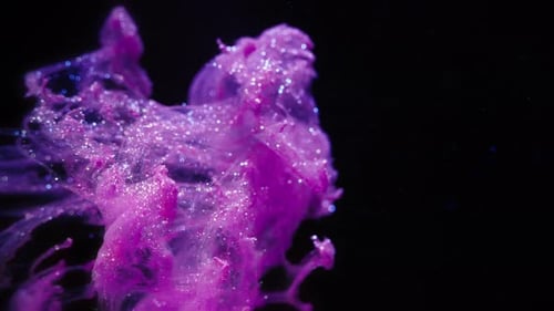 Real Ink Swirl with Sparkling Particles on Black Background