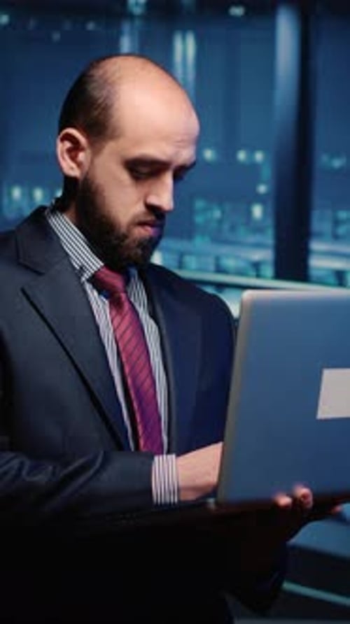 Businessman Working on Laptop in a High Tech Office