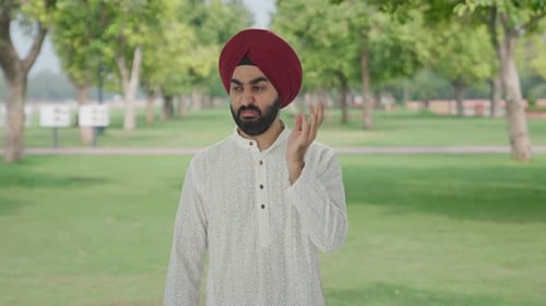 Disgusted Sikh Indian man frustrated by bad smell in park