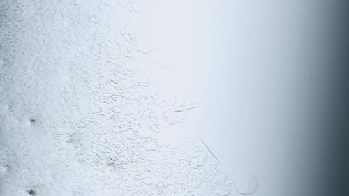 Abstract Ice Crystals Forming on Glass Surface
