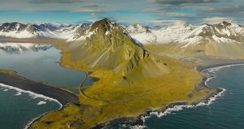 Aerial Perspective Of Snowy Mountains And Calm Waters