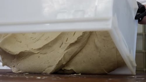 Pouring a Lot of Fresh Dough on the Table in the Bakery Pastries and Bread