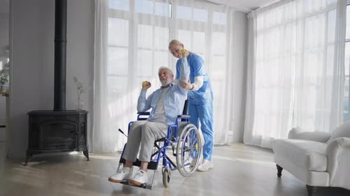 Senior Man in Wheelchair Doing Arm Exercises