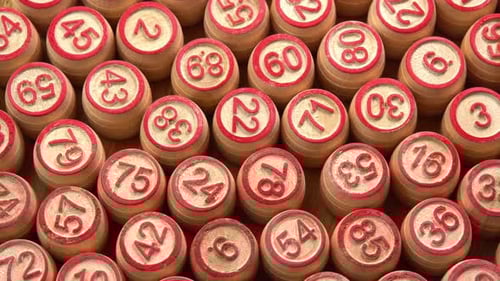 Lotto board game with wooden barrels with numbers close up rotate background top view. Bingo games