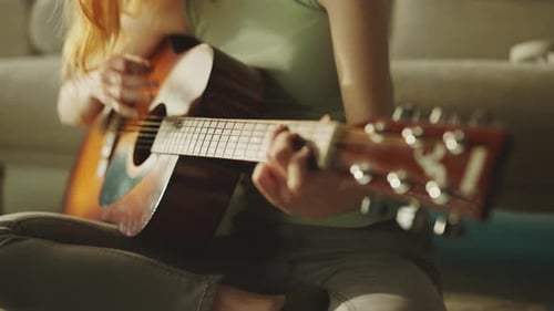 Smiling Woman Plays Guitar At Home
