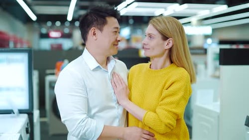 Portrait of a happy asian couple of consumers, supermarket shoppers or home appliances store looking