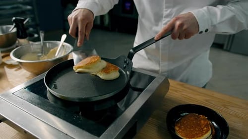 Chef Cooking Pancakes on a Griddle