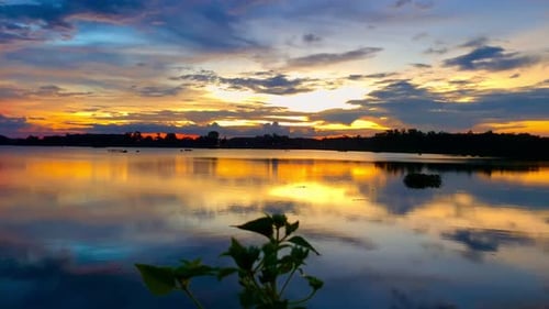 The beautiful sunset over the calm waters of the lake makes for a perfect view