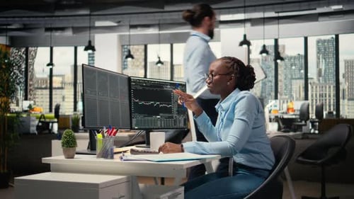 Financial Analyst in Prop Firm Office Doing Research on Stock Market Shares