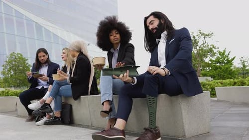 Diverse Young Adults Eating Lunch Together Outside Office