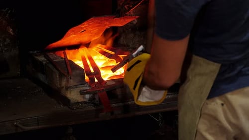 Man Working with Hot Metal in Furnace