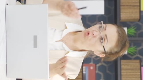 Woman Speaking During Virtual Meeting At Office Desk