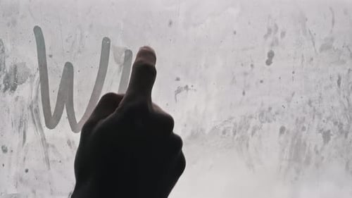 Hand Writing Winter on Frosted Glass